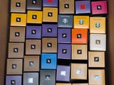 many boxes of different colors and sizes are stacked on top of each other