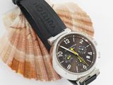 a watch sitting on top of a shell on a white surface