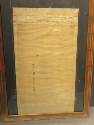 an old picture of a painting in a wooden frame on a table