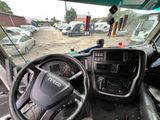 a view of the inside of a truck from the driver ' s seat