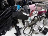 a table with a bunch of cameras and other electronics on it