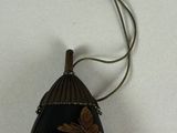 a picture of a black and gold necklace with a butterfly on it