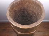 a large stone vase sitting on a wooden floor