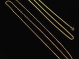 three gold chains on a black background