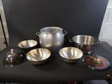 a lot of pots and pans sitting on a table