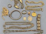 a collection of gold jewellery including a bracelet, ring, and other items