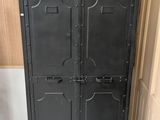 black metal locker cabinet with doors open in a room