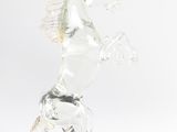 clear glass figurine of a horse standing on its hind legs