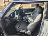 the interior of a small car with the door open and the steering wheel down