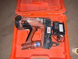 an orange case with a stapler and a stapler in it