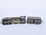 two toy trains sitting side by side on a white surface