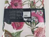 a pink and green floral napkin with a white background