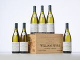 six bottles of white wine in a wooden crate on a table