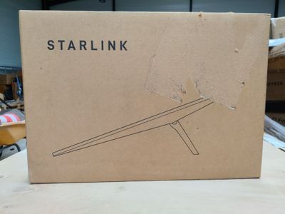 the box is open on a table with a wooden stand in it