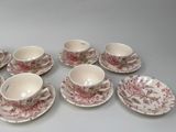 six cups and a saucer on the table