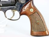 gun on a white surface with a white background