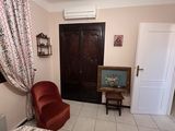 a living room with a couch, chair, table and a television