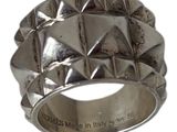 silver ring with rivets on the sides of the band