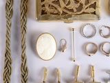 a lot of gold jewelry on a white surface
