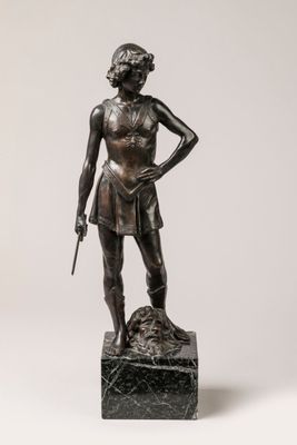 bronze statue of a woman holding a rifle and a dog