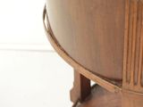 a close up of a wooden table with a clock on it