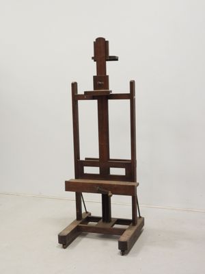 a wooden easel with a wooden seat on it