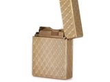 a gold lighter that is sitting on a white surface