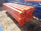 a pile of orange and blue steel bars stacked on top of each other