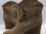 a close up of a pair of cowboy boots on a white background
