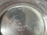 a silver plate with a label on it on a table