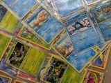 a pile of pokemon cards sitting on a table