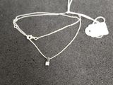 a necklace that has a heart and a key on it