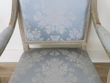 a blue and white chair sitting on a hard wood floor
