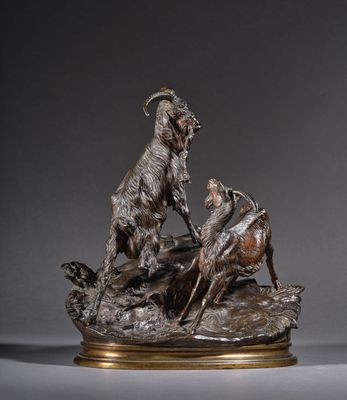 sculpture en bronze représentant une chèvre et un bélier sur un rocher
