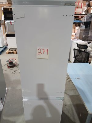 a refrigerator that is sitting in the middle of a room