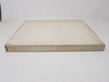 an old book sitting on a table with a white background