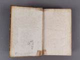an open book with writing on it sitting on top of a table