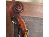 a close up of a violin that is hanging on a wall