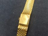 an image of a gold watch on a black surface