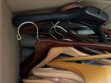 a box full of wooden clothes hangers and a pair of scissors