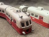two toy trains sitting next to each other on the floor