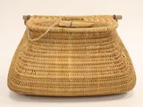 a close up of a wicker purse on a white background