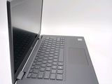 a black laptop with a silver keyboard on a white surface