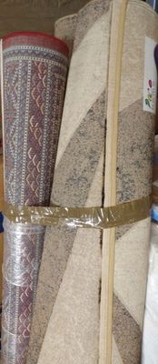 many different rugs stacked on top of each other