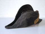 a black hat with a gold band on it