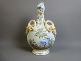 un vase bleu et blanc posé sur une surface grise