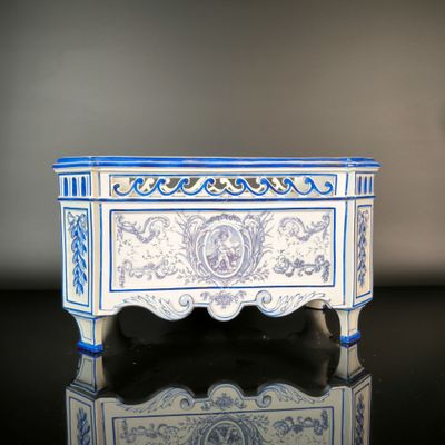 a small blue and white box on a black table