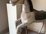 a wooden horse that is on display in a room