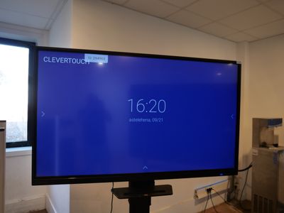 a large flat screen tv in the corner of a room