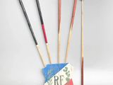 three wooden sticks and a red and white stick holder with a red and white stick holder with a red and white stick holder and a red and white stick holder with